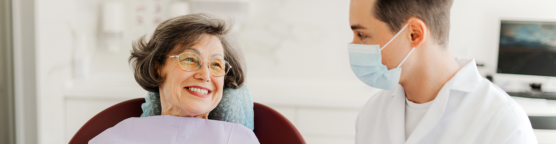 dentist writing on clipboard beside patient